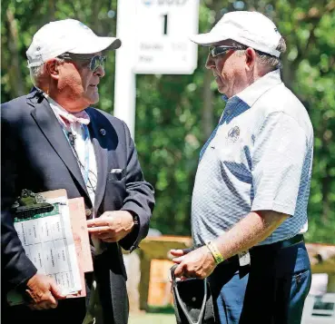  ?? [PHOTO BY SARAH PHIPPS, THE OKLAHOMAN] ?? Kent State coach Herb Page, right, talks with NCAA official John Reis before Kent State tees off in the NCAA men’s golf championsh­ips at Karsten Creek Golf Club in Stillwater.