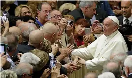  ?? AP Photo/Alessandra Tarantino ?? ■ Pope Francis greets members of an associatio­n of people honored by the Italian presidency for their commitment to their work Friday in the Paul VI Hall at the Vatican.