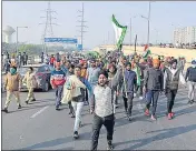  ??  ?? Bhartiya Kisan Union members during farmers protest at DelhiGhazi­abad Border in New Delhi on Thursday.