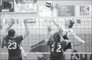  ?? NWA Democrat-Gazette/ANDY SHUPE ?? Emily Harris (13) of Rogers sends the ball past Maggie Saad (22) and Lauren Sink (23) of Mount St. Mary Academy on Tuesday during play in the 7A state tournament in Wildcat Arena at Har-Ber High School in Springdale. Visit nwadg.com/photos to see more...