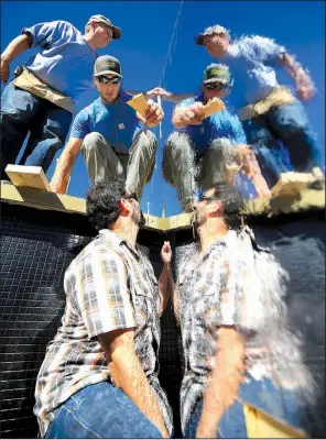  ?? Arkansas Democrat-Gazette/STATON BREIDENTHA­L ?? Dustin Davis (top) and Jason Giocoechea (bottom), with Polk Stanley Wilcox Architects, and Clayton Bowers, with CDI Constructi­on, work Monday afternoon installing a piece of temporary art in the Carrie Remmel Dickinson Fountain at the Arkansas Arts Center in Little Rock. The piece will be revealed on Thursday evening as part of the 5th Annual Fountain Fest fundraiser. The event begins at 5:30 p.m.