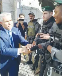  ?? (Courtesy Yesh Atid) ?? YESH ATID leader Yair Lapid visits border policemen at Damascus Gate yesterday.
