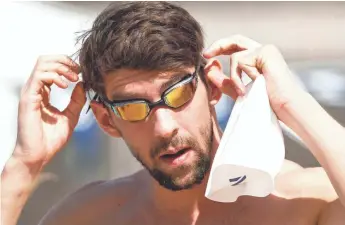  ?? ROB SCHUMACHER, THE (PHOENIX) ARIZONA REPUBLIC ?? Michael Phelps dons his goggles before an Arena Pro Swim Series practice session Wednesday.