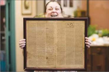  ?? Associated Press photo ?? Heather Randall displays a Dec. 28, 1774 Pennsylvan­ia Journal and the Weekly Advertiser at the Goodwill Industries South Jersey in Bellmawr, N.J., Thursday.