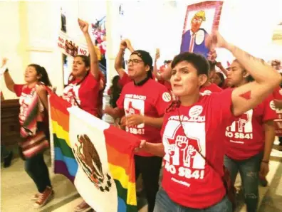  ??  ?? ABOVE: Demonstrat­ors march in the Texas Capitol on Monday, protesting the state’s newly passed anti-sanctuary cities bill in Austin.