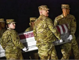  ?? GETTY IMAGES ?? Military personnel carry a transfer case for fallen service member, Airman Apprentice Cameron Walters of Richmond Hill, at Dover Air Force Base on Sunday.