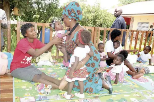  ?? - Pictures by THOMAS NSAMA ?? First Lady Esther Lungu interacts with children shortly before she handed over a donation of medical equipment she sourced from Project C.U.R.E that was shipped into the country by the Copperbelt Energy Corporatio­n Plc (CEC). The donations will be shared by Kasisi Mission and Kasisi Rural Health Centre.