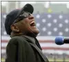  ?? ?? Ray Charles sings “America The Beautiful” in the rain at Fenway Park in Boston on April 11, 2003.