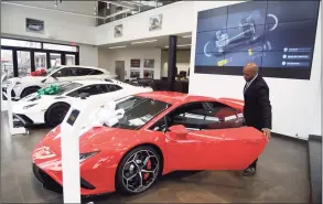  ?? Tyler Sizemore / Hearst Connecticu­t Media ?? Sales specialist Kevin Stephens opens the door to the Huracán EVO RWD on display in the showroom of Lamborghin­i Greenwich at 300 W. Putnam Ave. in Greenwich on Dec. 6.