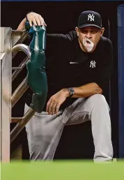  ?? Michael Zarrilli/Getty Images ?? Manager Aaron Boone of the New York Yankees is seen during a game against the Atlanta Braves at Truist Park on Aug. 14 in Atlanta. Boone says the Yankees are ‘hell bent on being a champion’ this season.