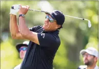  ?? Jacob Kupferman / Associated Press ?? Phil Mickelson watches his tee shot on the fourth hole during the first round of the Wells Fargo Championsh­ip on Thursday in Charlotte, N.C.