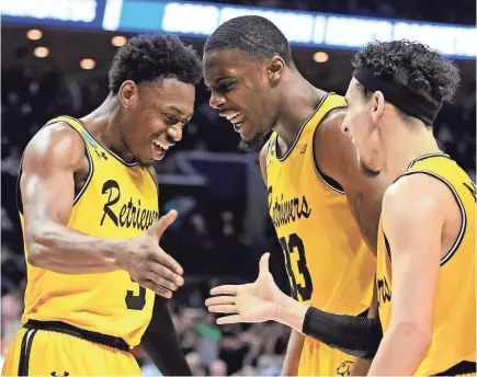  ?? BOB DONNAN/USA TODAY SPORTS ?? Maryland-Baltimore County players celebrate during their first-round upset of Virginia in 2018.