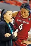  ?? AP PHOTO/BUTCH DILL ?? South Carolina coach Dawn Staley talks with forward Aliyah Boston during the Gamecocks’ 83-48 win at Auburn on Thursday.