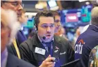  ?? RICHARD DREW/ASSOCIATED PRESS ?? Trader Joseph Lawler works on the floor of the New York Stock Exchange. The S&P 500 index closed Thursday at a record high.