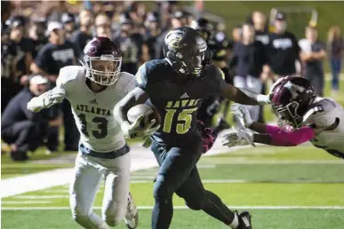  ?? Staff photo by Evan Lewis ?? Pleasant Grove fullback TJ Cole keeps the Atlanta defense at arms length on his way to the Hawks’ third touchdown Friday. The Hawks beat the Rabbits, 48-17.