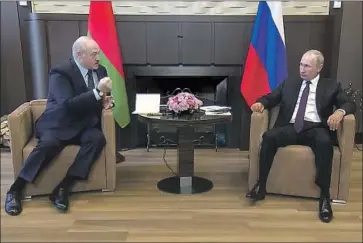  ?? Associated Press ?? BELARUSIAN PRESIDENT Alexander Lukashenko, left, met with Russian President Vladimir Putin on Monday in Sochi, Russia. Belarus’ authoritar­ian leader is seeking loans and political support from Russia.