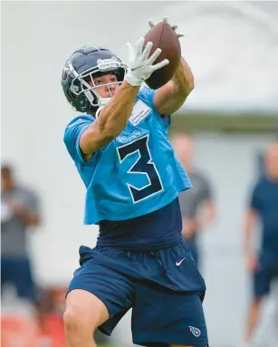  ?? MARK HUMPHREY/AP PHOTOS ?? Tennessee Titans cornerback Caleb Farley pulls in a pass during training camp Friday in Nashville. The former Virginia Tech star tore his left ACL on Oct. 18 that ended his rookie season.