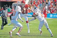  ??  ?? OU's Spencer Rattler (7) runs between Texas' DeMarvion Overshown (0) and Juwan Mitchell (6) during the Red River Showdown on Oct. 10. [BRYAN TERRY/ THE OKLAHOMAN]