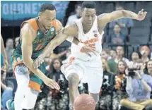  ?? MARY ALTAFFER/AP ?? Miami guard Bruce Brown (11) and Syracuse guard Tyus Battle (25) chase a loose ball during the Hurricanes victory on Wednesday.