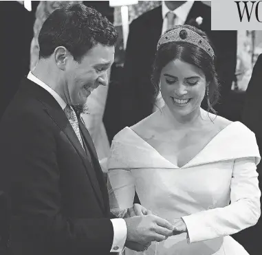  ?? JONATHAN BRADY/AFP/GETTY IMAGES ?? Britain’s Princess Eugenie of York receives the ring from Jack Brooksbank during their star-studded wedding ceremony at Windsor’s St. George’s Chapel Friday, a day that included such celebritie­s as Liv Tyler and Naomi Campbell.