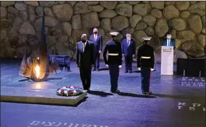  ??  ?? U.S. Defense Secretary Lloyd Austin (left) attends a service Monday at the Hall of Remembranc­e in the Yad Vashem Holocaust Museum in Jerusalem. Austin began his trip Sunday in Israel. (AP/Robert Burns)