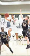  ?? / Tim Godbee ?? Calhoun’s Xaxton Goodson coasts past the East Hall defense for a basket on Saturday during the team’s first-round state playoff victory.