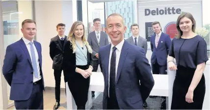  ??  ?? > Ross Flanigan, front, managing director of Deloitte’s Cardiff Delivery Centre with other staff