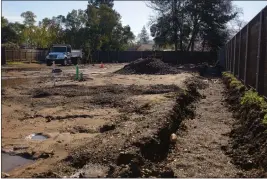  ?? PHOTOS BY MICHAEL WEBER — ENTERPRISE-RECORD ?? A trench is dug out of the ground for drainage at the Everhart Village project site on Wednesday in Chico.