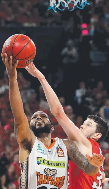  ?? Picture: AAP ?? HANGING TOUGH: DJ Newbill of the Taipans drives to the basket under pressure from Clint Steindl of the Wildcats during the NBL semi-final at RAC Arena in Perth.