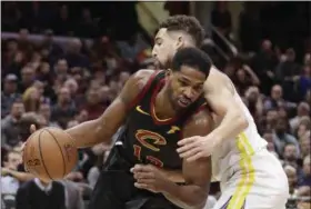  ?? TONY DEJAK — THE ASSOCIATED PRESS ?? The Cavaliers’ Tristan Thompson drives past the Warriors’ Klay Thompson in the first half Dec. 5 at Quicken Loans Arena.
