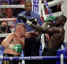  ?? John Gurzinski/Getty Images ?? British boxer Tyson Fury, left, pummeled American Deontay Wilder to win the heavyweigh­t title in Las Vegas.