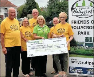  ??  ?? Hinckley Asda community champion Marie Eaves presents a cheque for £345 to Friends of Hollycroft Park, from left, Malcolm Simpson, Margaret Parker, Rod Parker, John Jeffrey and chairman Dawn Jeffrey to help pay for new lights in the park bandstand,...