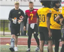  ?? THE CANADIAN PRESS ?? The Ticats' Bo Levi Mitchell was in a walking boot as camp opened Sunday, but the team says it's just a precaution.