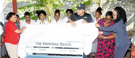  ?? CONTRIBUTE­D ?? Health Minister Dr Christophe­r Tufton (fourth right) takes part in the unveiling of a new ‘wellness bench’ for the Montego Bay High School for Girls in St James, along with teachers and students of the institutio­n yesterday.