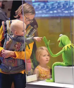  ?? JIM THOMPSON/JOURNAL ?? Laura Shank, Arlo and Ebba check out the Kermit the frog puppet as they enter “The Jim Henson Exhibition: Imaginatio­n Unlimited” at the Albuquerqu­e Museum.