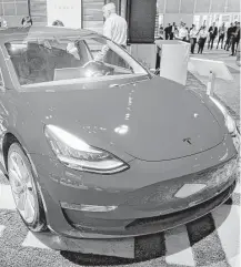  ?? Patrick T. Fallon / Bloomberg file ?? The Tesla Model 3 vehicle is displayed in Los Angeles.