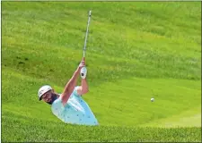  ?? FRANK FRANKLIN II/AP PHOTO ?? Masters champion Jon Rahm, ranked No. 2 in the world, hits out of a bunker on the 18th hole during the Travelers Championsh­ip Pro-Am on Wednesday at TPC River Highlands in Cromwell.