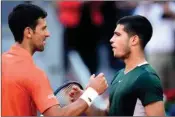  ?? PTI ?? Novak Djokovic, left, shakes hands with Carlos Alcaraz at the end of a men's semifinal at the Mutua Madrid Open tennis tournament in Madrid, Spain