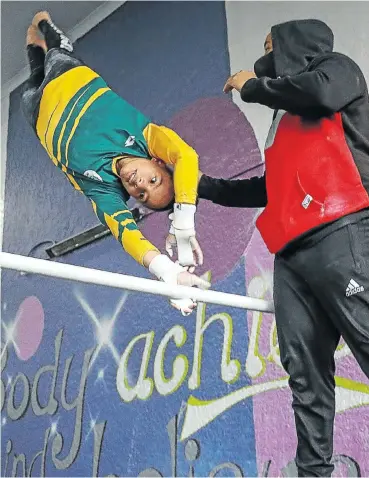  ?? Picture: Sebabatso Mosamo ?? Caitlin Rooskrantz, training under the watchful eye of Leeland Christian, one of the coaches at the Johannesbu­rg Gymnastics Centre in Newlands, says when she is in full flight she trains for about four-and-a-half hours a day, six days a week.