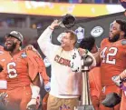  ??  ?? Clemson, including coach Dabo Swinney, celebrates after routing Miami (Fla.) 38-3 to win the ACC championsh­ip game in Charlotte. BOB DONNAN/USA TODAY SPORTS