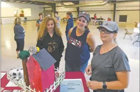  ?? NWA Democrat-Gazette/Flip Putthoff ?? Riley Wanket (left), a member of Cannonball 4-H in Pea Ridge, and her mom, Angela Wanket (center) hear Saturday informatio­n from Linda Simpson, a Benton County Fair superinten­dent, about entering the 117th annual Benton County Fair set for Sept. 28-Oct. 2.