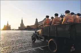  ?? Alexander Zemlianich­enko / Associated Press ?? Russian soldiers dressed in Red Army World War II uniform during a parade on Wednesday with St. Basil Cathedral and the Spasskaya Tower in the background in Red Square in Moscow. The parade marked the 77th anniversar­y of a World War II historic parade in Red Square and honored the participan­ts in the Nov. 7, 1941, parade who headed directly to the front lines to defend Moscow from Nazi forces.