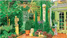  ??  ?? Statues, bedding plants and cypress trees next to the ornate wooden tool shed