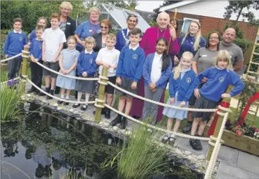  ?? Pictures: Paul Amos FM4809216 ?? The Right Rev Trevor Wilmott Bishop of Dover in the spiritual garden with pupils and staff at Ashford St Marys Primary School