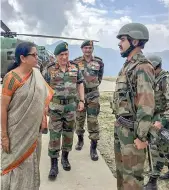  ?? —PTI ?? Defence minister Nirmala Sitharaman with Army Chief Gen. Bipin Rawat interacts with troops of the 28 Inf Div on their visit to the Balbir forward post in Keran sector, Jammu and Kashmir on Sunday.