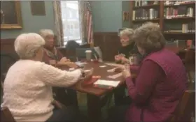  ?? ZACHARY SRNIS — THE MORNING JOURNAL ?? Ruth Maurer, front left, Barbara Enfield, front right, Judy Williams, back left, Dianne Mosley, back right, all from Vermilion, play bridge weekly at Ritter Public Library in Vermilion.