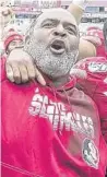  ?? MARK WALLHEISER/AP ?? FSU interim coach Odell Haggins celebrates with players after Seminoles became bowl eligible after a win over Alabama State.