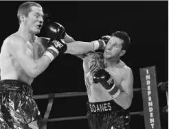  ?? SHAUGHN BUTTS/ EDMONTON JOURNAL FILES ?? Steve MacGilliva­ry of Edmonton, left, takes a punch from Brad Soanes of Medicine Hat at the Shaw Conference Centre June 22.