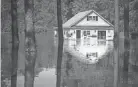  ?? ANDREW CRAFT/THE FAYETTEVIL­LE OBSERVER VIA AP, FILE ?? Flood buyout programs typically purchase flood-prone homes, raze them and turn the property into green space.