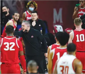  ?? JULIO CORTEZ / AP ?? Ohio State coach Chris Holtmann, center, reacts during a game Feb. 8 in College Park, Md., against Maryland. The Buckeyes are the No. 2 seed in the NCAA South Regional.